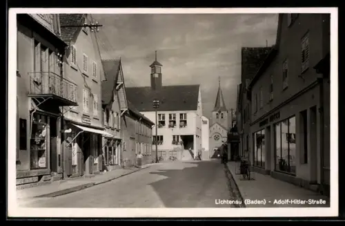AK Lichtenau /Baden, Strasse mit Geschäften, Turmgebäude und Kirche