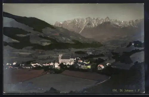 AK St. Johann i. P., Panorama mit Kirche und Gebirgskulisse