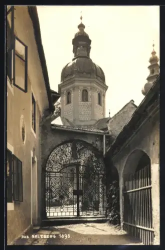 AK Salzburg, Durchgang mit schmiedeeisernem Tor und Kirchenkuppel