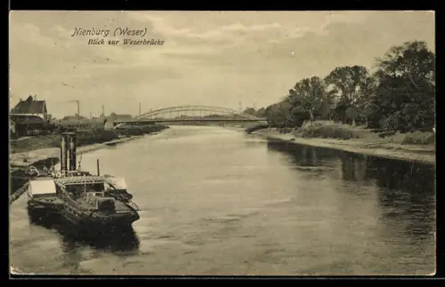 AK Nienburg /Weser, Weserpartie mit Brücke, Frachter