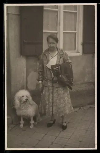 Foto-AK Dame mit Pudel vor einem Haus