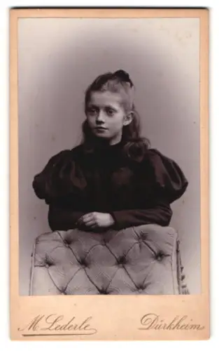 Fotografie M. Lederle, Dürkheim a. H., Mädchen in dunklem Kleid an einem Sessel