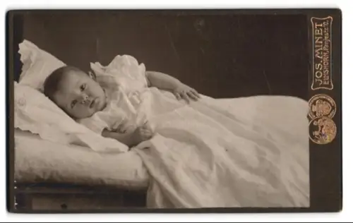 Fotografie Jos. Minet, Elmshorn, Panjestrasse 10, Porträt eines liegenden Babys