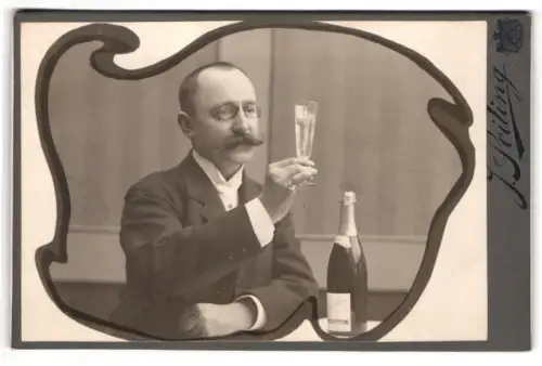 Fotografie J. Seiling, München, Prielmayerstr. 18, Eleganter Herr mit Brille hebt ein Sektglas