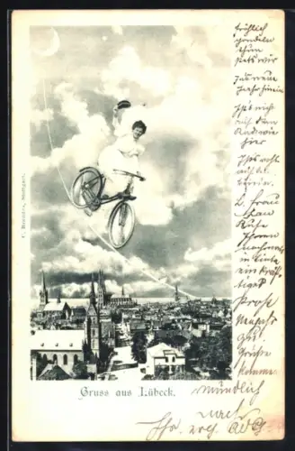 AK Lübeck, Dame auf Fahrrad in der Luft über der Stadt