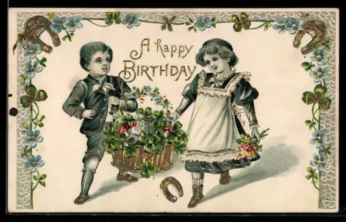 Präge-AK Kinder tragen einen Korb mit Kleeblättern, Hufeisen und Geldsäcken, A happy Birthday