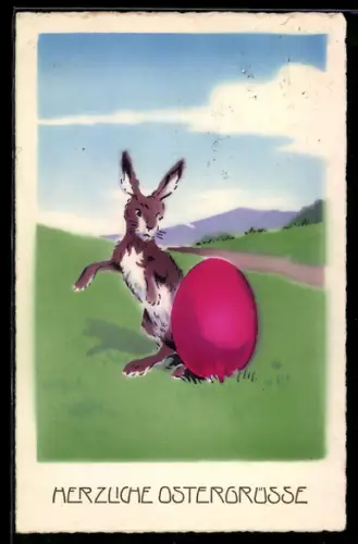 AK Osterhase neben einem grossen bemalten Ei auf einer Wiese