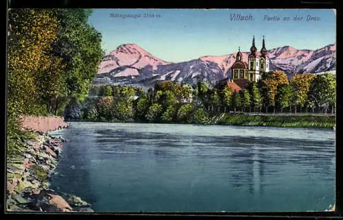 AK Villach, Partie an der Drau mit Kirche und Mittagskogel