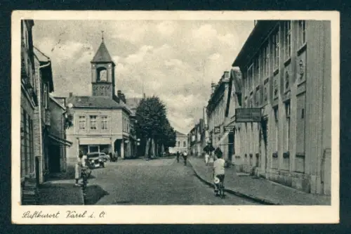 AK Varel i. O., Strassenpartie mit Kirchturm und Geschäftshäusern