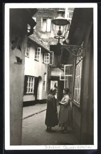 Foto-AK Lübeck, Düstere Querstrasse, Partie mit Anwohnerinnen, 1928