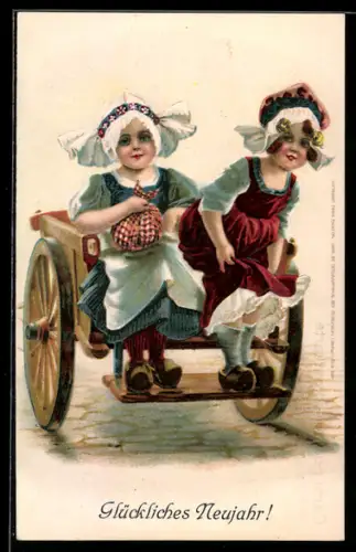 AK zwei niedliche Mädchen in niederländischer Tracht auf einem Holzwagen sitzend