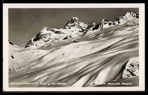 AK Heilbronnerhütte, Berghütte mit Patteriol im Schnee