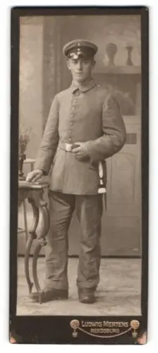 Fotografie Ludwig Mertens, Rendsburg, Am Gymnasium, Soldat in Feldgrau Uniform mit Schirmmütze und Bajonett