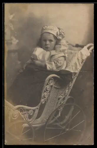 Foto-AK Kleines Mädchen in einem verzierten Korb-Kinderwagen