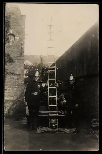 Foto-AK Zwei Feuerwehrmänner mit Leiter am Feuerwehrauto