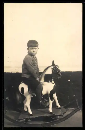 Foto-AK Junge auf einem Schaukelpferd