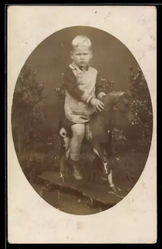 Foto-AK Junge auf einem Pferd auf Rollen