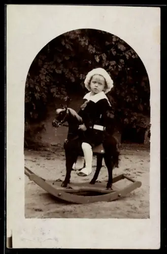 Foto-AK Kleinkind im Garten auf einem Schaukelpferd