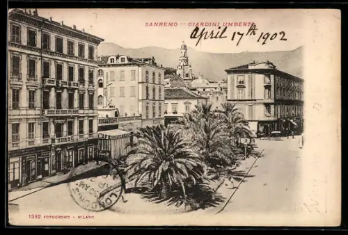 AK Sanremo, Giardini Umberto, Vista sui giardini e edifici storici con palme e montagna sullo sfondo