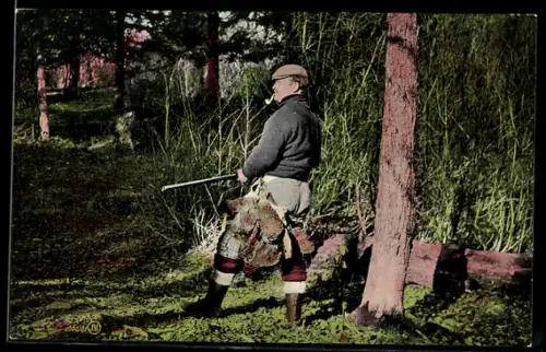 Foto-AK Jäger mit Gewehr und Pfeife bei einem Waldstück