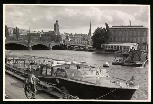 Fotografie Ansicht Stockholm, Angelegte Schiffe mit Brücke und Kirche im Hintergrund