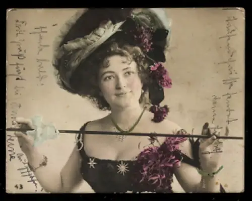 Mini-AK Schöne Frau mit auffälligem Hut und einem Stock in der Hand