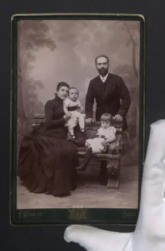 Fotografie E. Stoklas, Baden, Neugasse 57, Familienportrait mit zwei Kleinkindern auf einer Bank