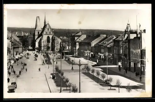 AK Rakovnik, Platzansicht mit Kirche und Passanten