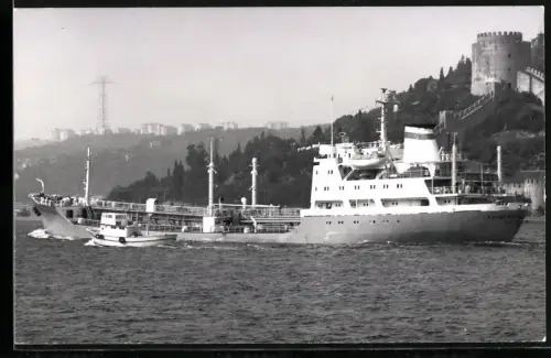 Fotografie Sowjetisches Frachtschiff Kapitan Nerezhkin mit begleitender Barkasse in Fahrt vor einer Burg