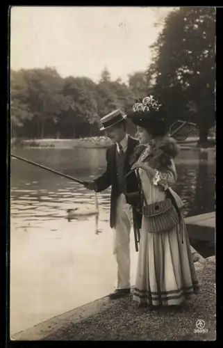 AK Elegantes Paar am Ufer beim Angeln
