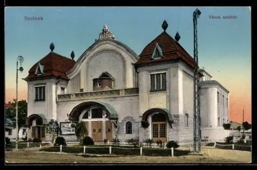 AK Szolnok, Városi szinház, Ansicht im Abendlicht
