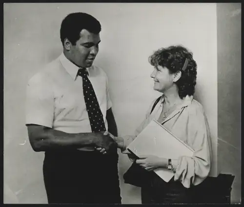Fotografie Boxer Muhammad Ali schüttelt die Hand einer lächelnden Frau
