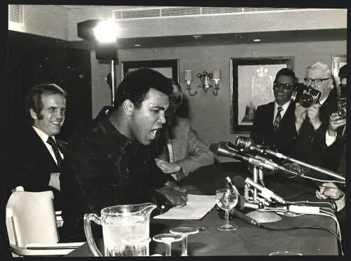 Fotografie Boxer Muhammad Ali spricht in Mikrofone