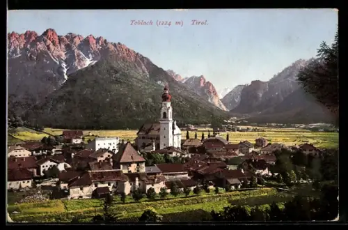 AK Toblach, Vista panoramica del villaggio con chiesa e montagne sullo sfondo