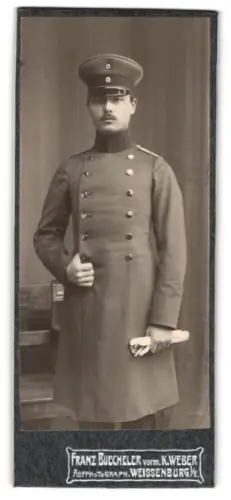 Fotografie Franz Buechler, Weissenburg i. E., Leutnant im Überrock mit Schirmmütze