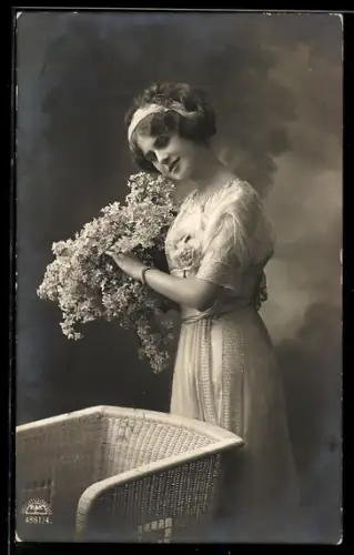 Foto-AK R & K / L Nr. 4881/4: Junge Dame mit Fliederstrauss, Korbsessel