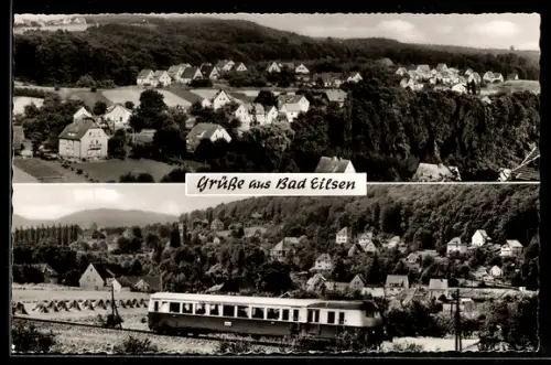 AK Bad Eilsen, Ortsansicht und Triebwagen vor bewaldeter Kulisse