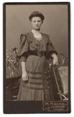 Fotografie M. Hähnel, Jahnsdorf v. Erzgeb., Stehende Frau neben verziertem Stuhl
