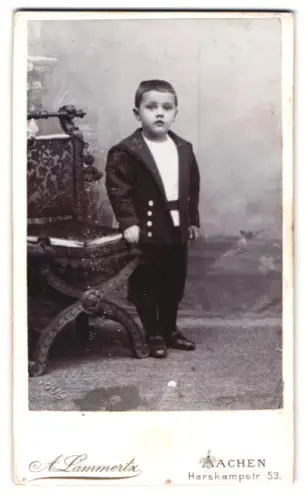 Fotografie A. Lammertz, Aachen, Harskampstr. 53, Junge in Anzug neben Stuhl