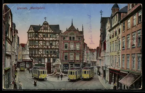 AK Giessen, Marktplatz mit Strassenbahnen, Geschäfte, Denkmal