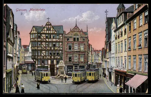 AK Giessen, Marktplatz mit Strassenbahnen, Geschäfte, Denkmal