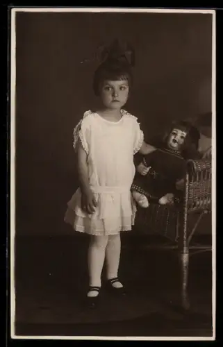 Foto-AK Mädchen mit Schleife im Haar mit ihrer Puppe