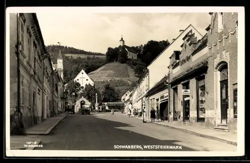 AK Schwanberg /Weststeiermark, Strassenpartie mit Geschäft Gottfried Mayer u. Kirchen