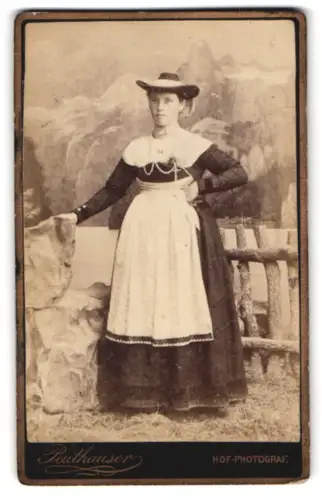 Fotografie Peuthauser, Bad Krankenheil, Dame in Tracht mit Schürze vor Bergkulisse
