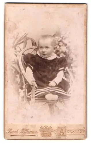 Fotografie Bernh. Hoffmann, Arnstadt, Kleinkind auf einem Korbstuhl