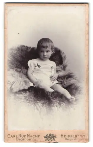 Fotografie Carl Ruf Nachf., Heidelberg, Hauptstr., Kind auf einem Fell sitzend