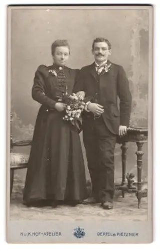 Fotografie Bertel & Pietzner, Salzburg, Schwarzstrasse 19, Elegantes junges Brautpaar mit Blumenstrauss im Atelier