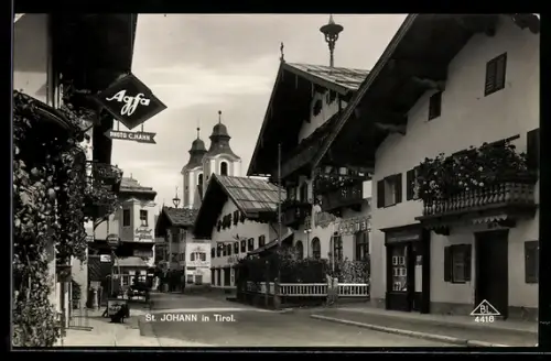 AK St. Johann in Tirol, Strasse mit Photogeschäft und Kirche