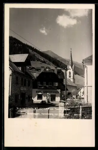AK St. Johann am Tauern, Dorfstrasse mit Kirche und Kaufhaus Karl Grassegger