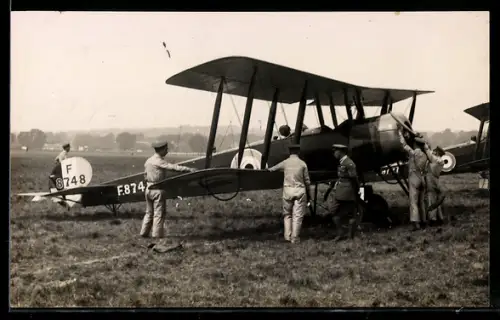 AK Doppeldecker-Flugzeug bei Startvorbereitungen auf einem Flugfeld